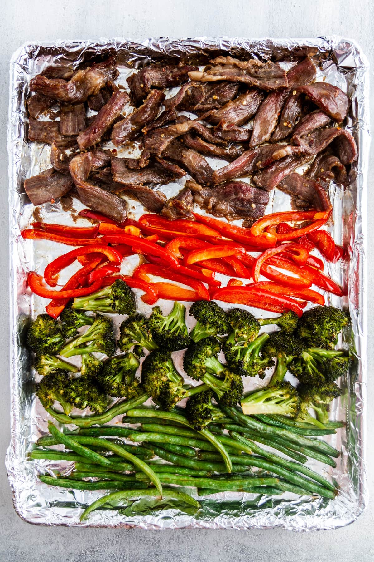 mongolian beef and vegetables on a sheet pan