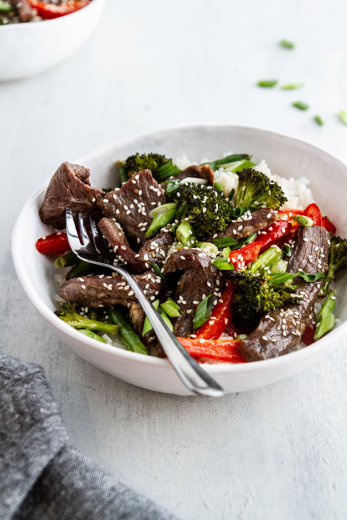 a bowl of sheet pan mongolian beef on a surface