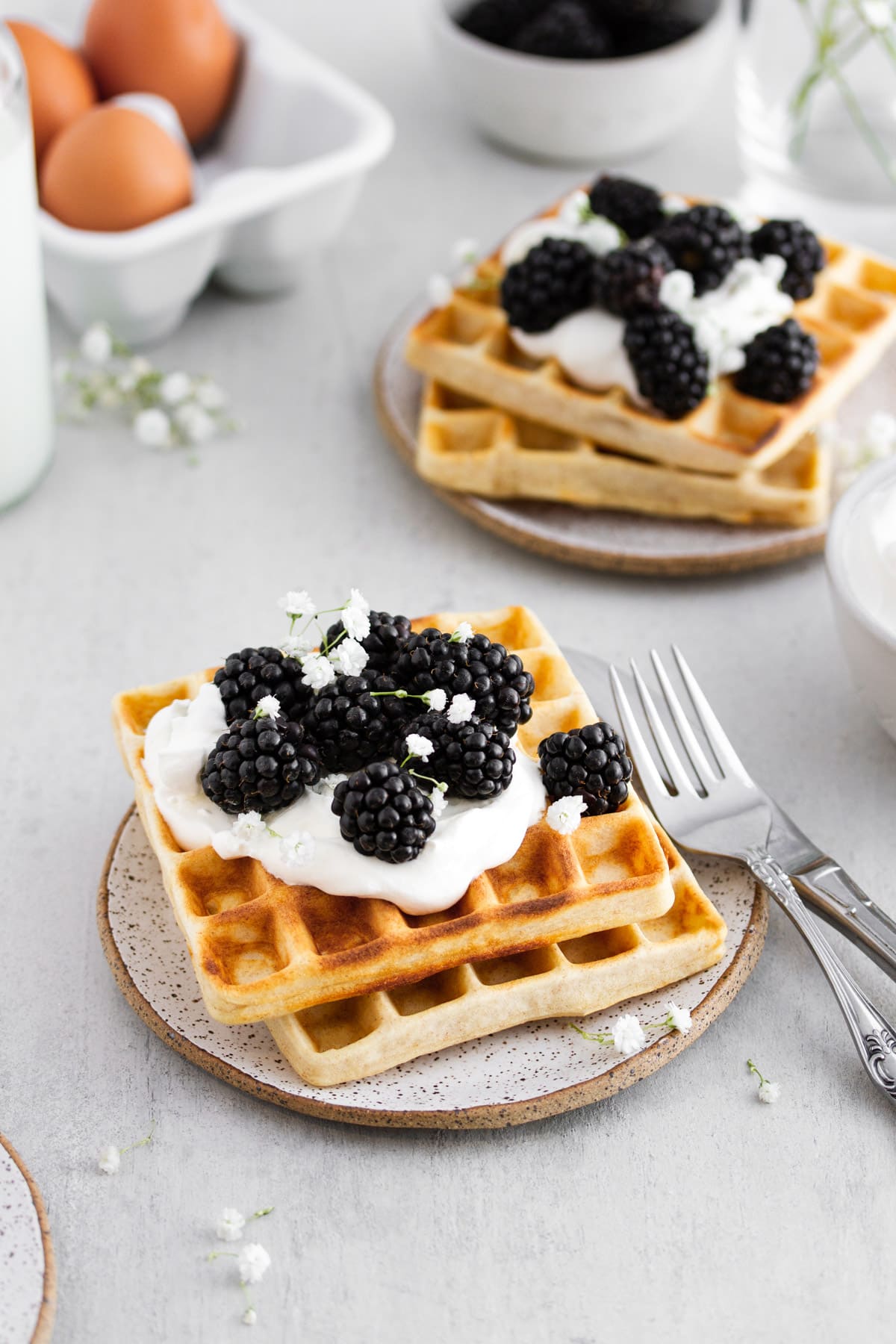 sourdough waffles with whipped cream and berries on a plate
