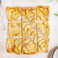 French apple tart cut up on a surface