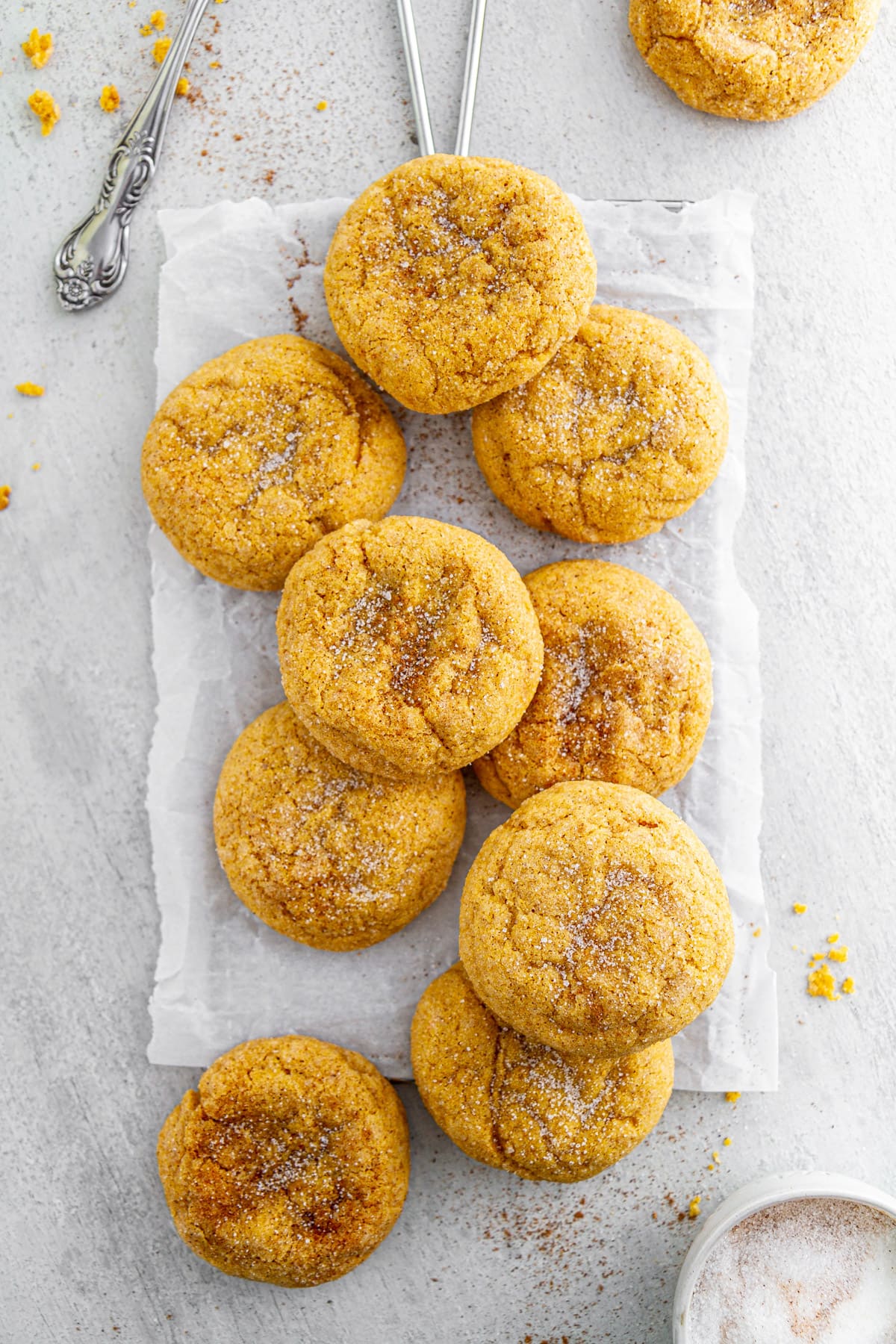 pumpkin snickerdoodles on a parchment paper-lined cooling rack