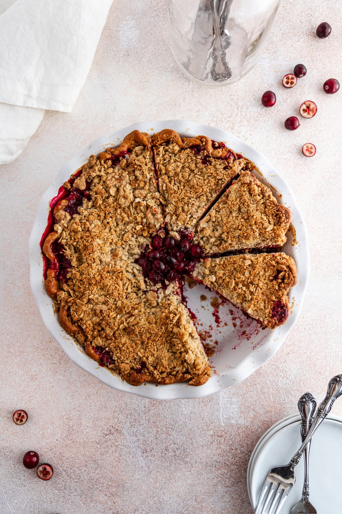 cranberry crumble pie on a surface with a slice taken out