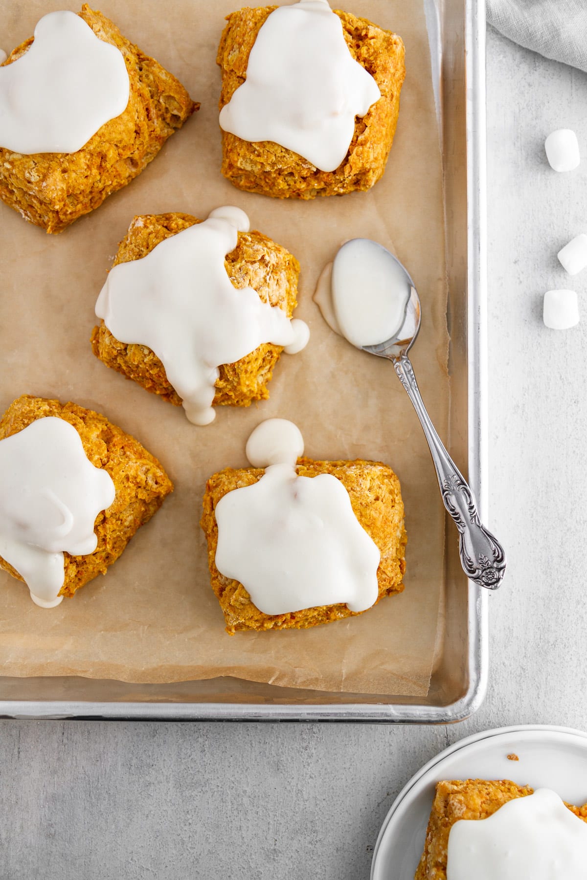 sweet potato biscuits on a baking sheet with marshmallow icing on top