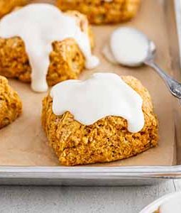 sweet potato biscuits with marshmallow icing on a baking sheet