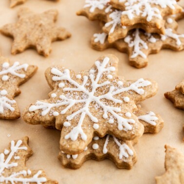 eggnog latte cutout cookies stacked on parchment paper.