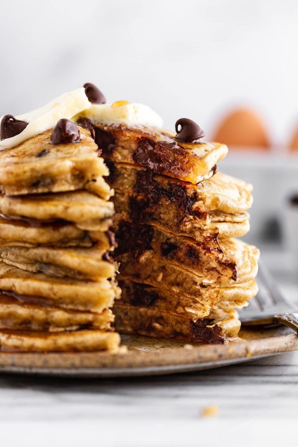 cross-section of oatmeal chocolate chip cookie pancakes on a plate.