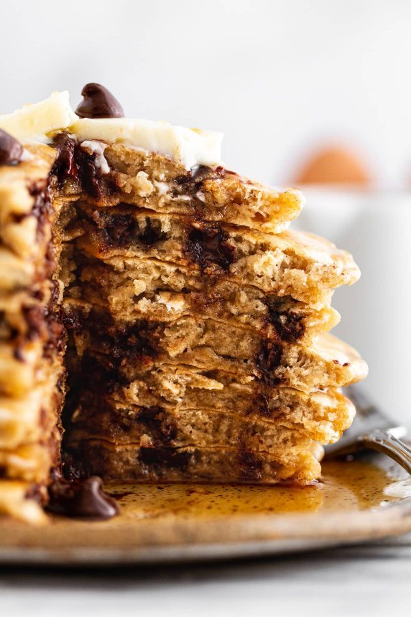 cross-section of oatmeal chocolate chip cookie pancakes on a plate.