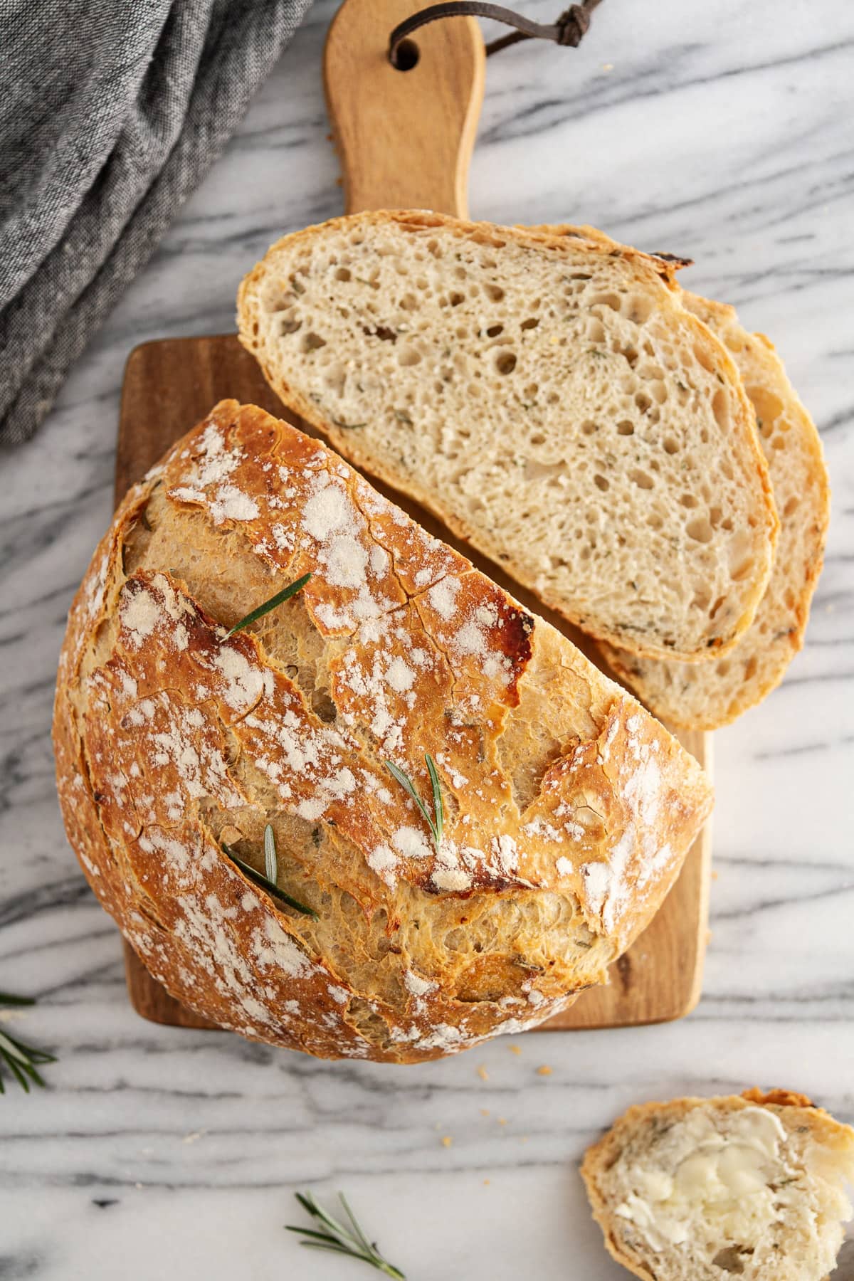 sliced rosemary-garlic no-knead bread on a cutting board