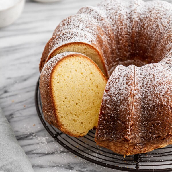 a sliced sour cream pound cake on a cooling rack.