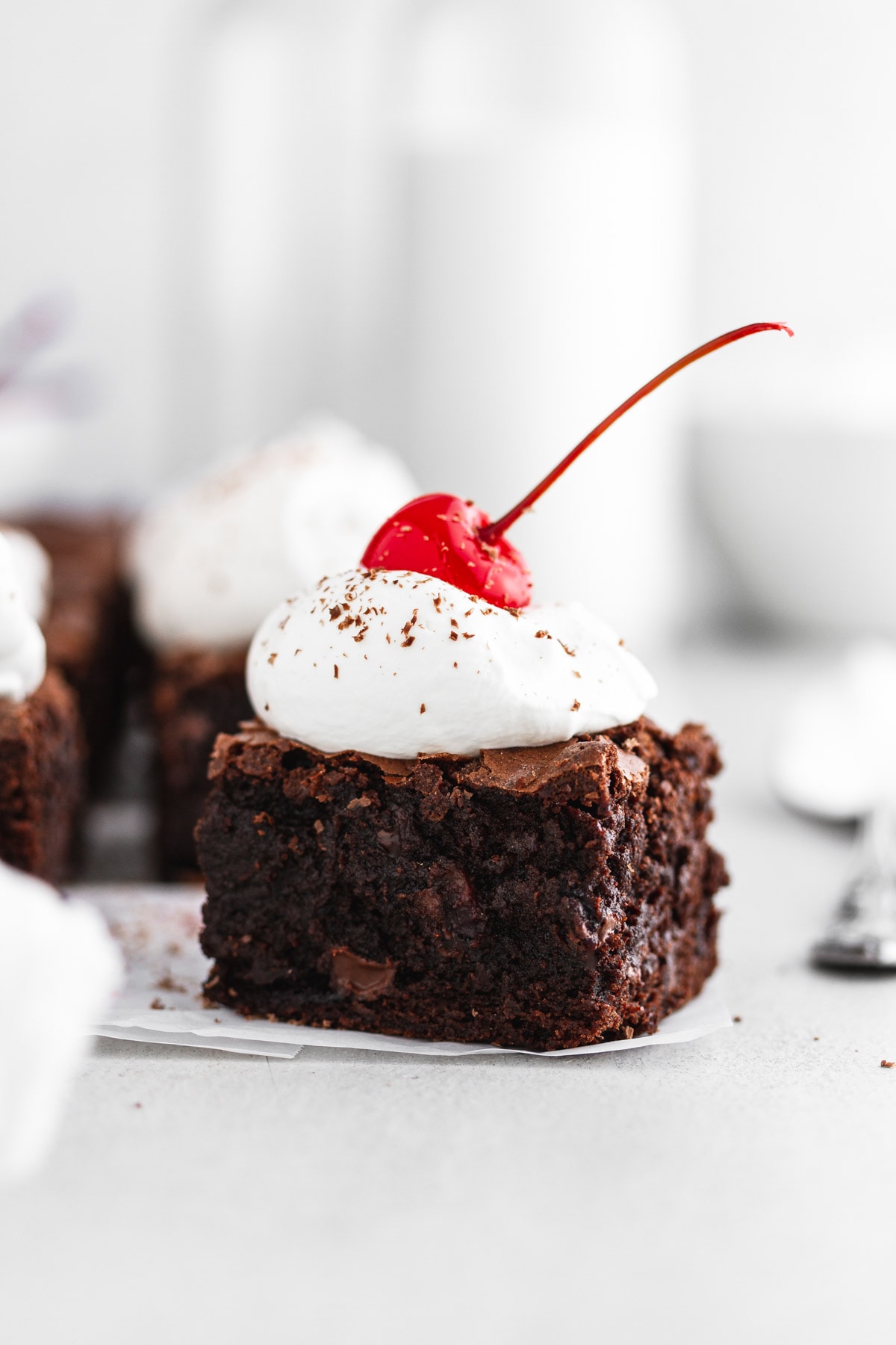 close-up of a black forest cherry brownie on parchment paper
