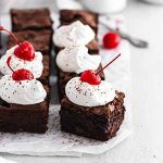 black forest cherry brownies on parchment paper.