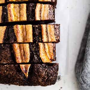 sliced chocolate banana bread on a surface.