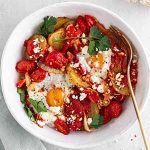 shakshuka in a bowl on a surface.