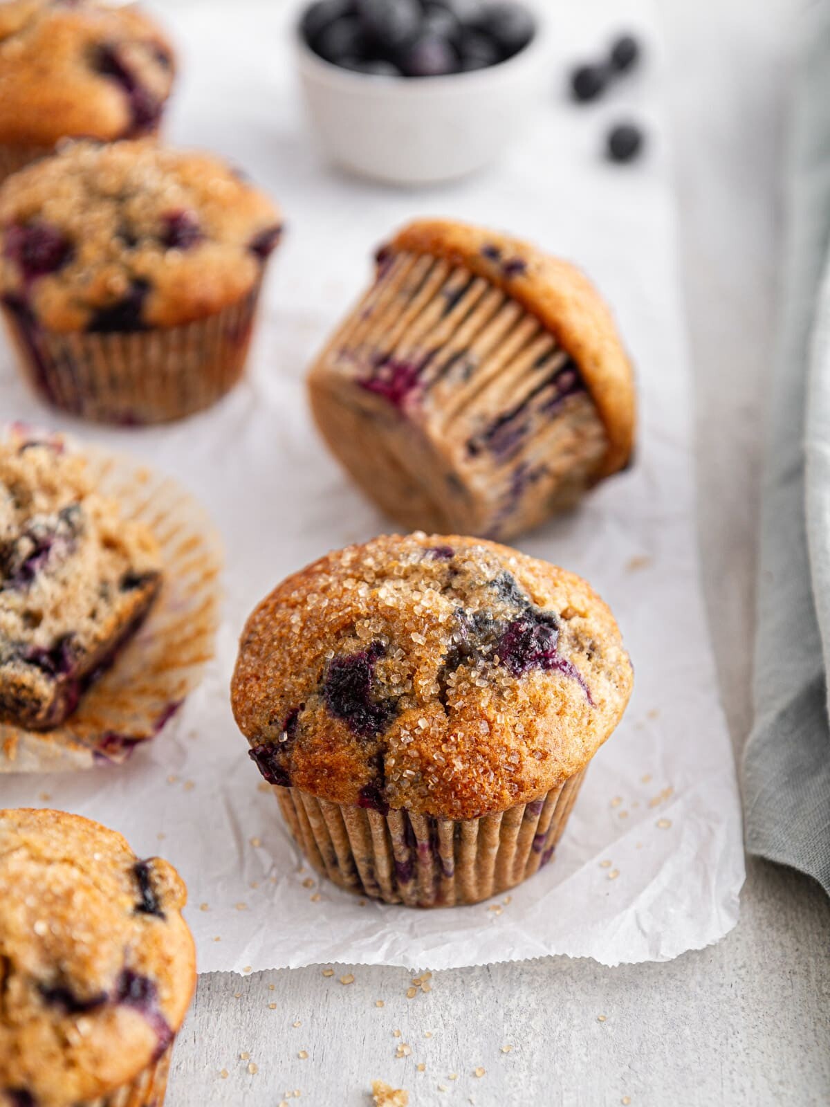 sourdough blueberry muffins on parchment paper.