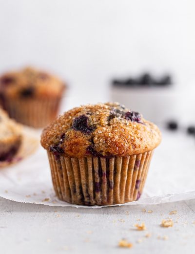 close-up of a sourdough blueberry muffin on parchment paper