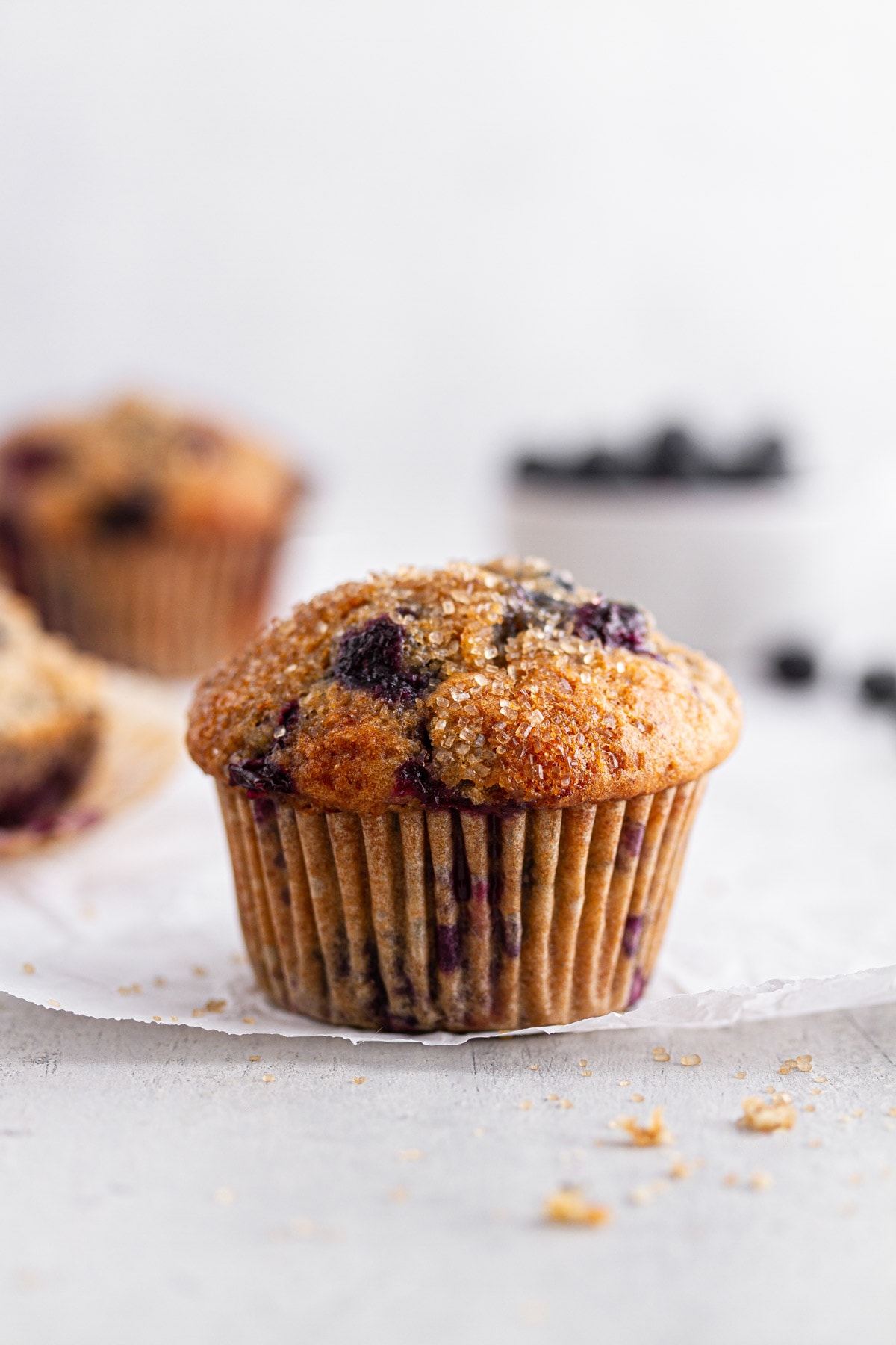 close-up of a sourdough blueberry muffin on parchment paper