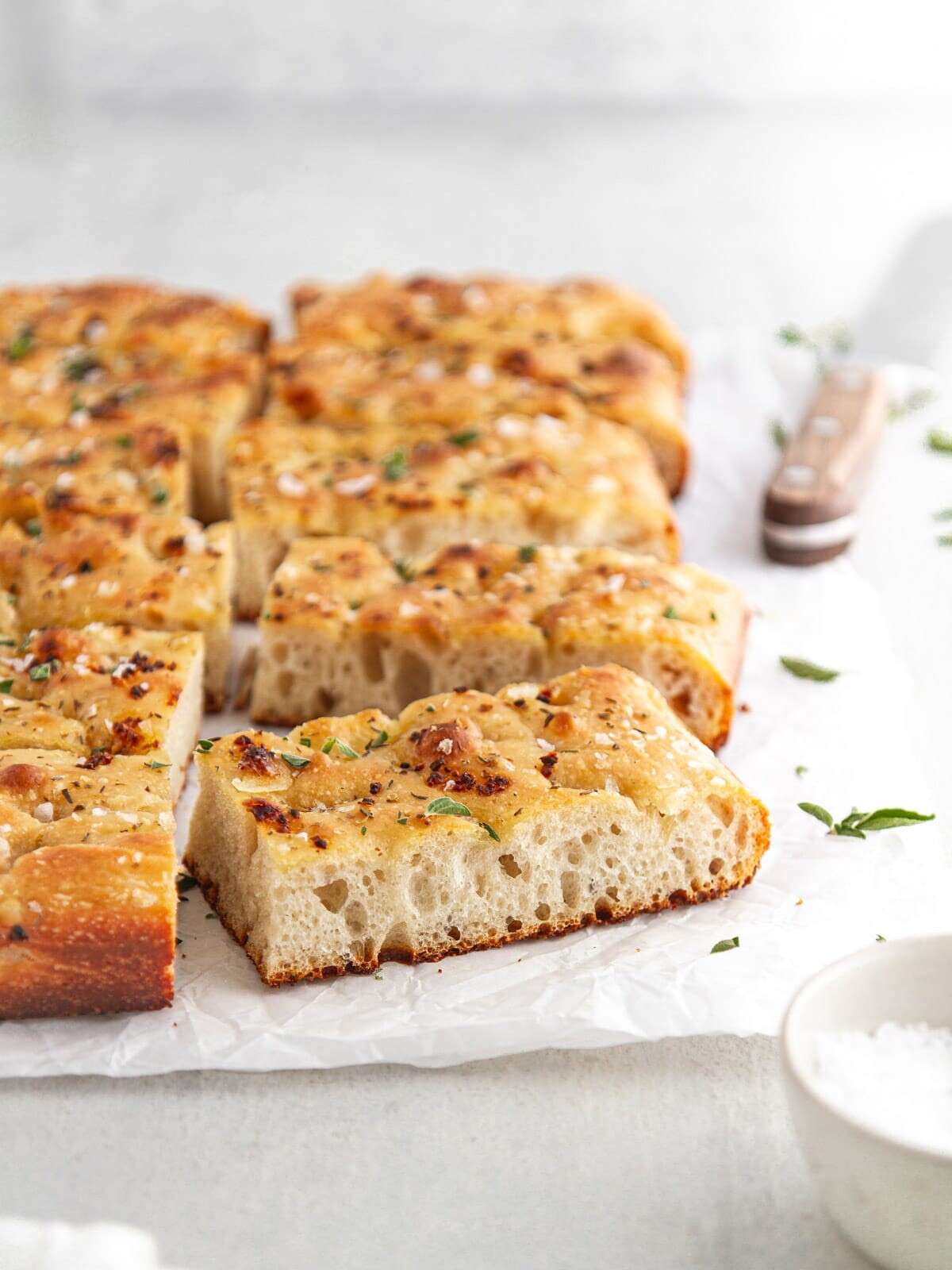 slices of sourdough focaccia bread on parchment paper.