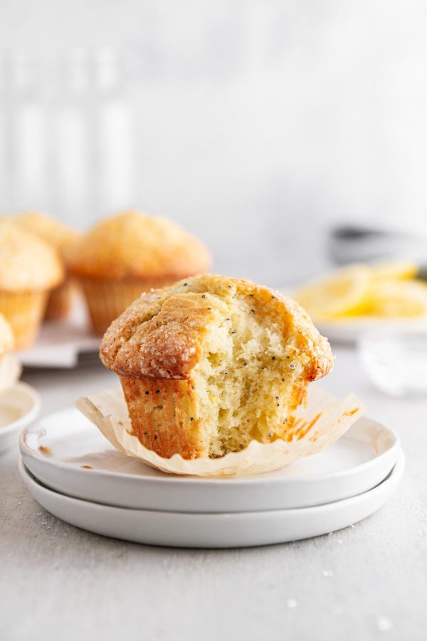 lemon poppy seed muffin on a plate with a bite taken out