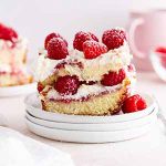 a piece of raspberry pound cake tiramisu on a stack of plates.