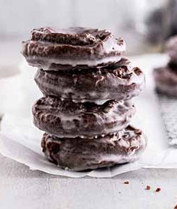 stacked chocolate old-fashioned donuts on parchment paper