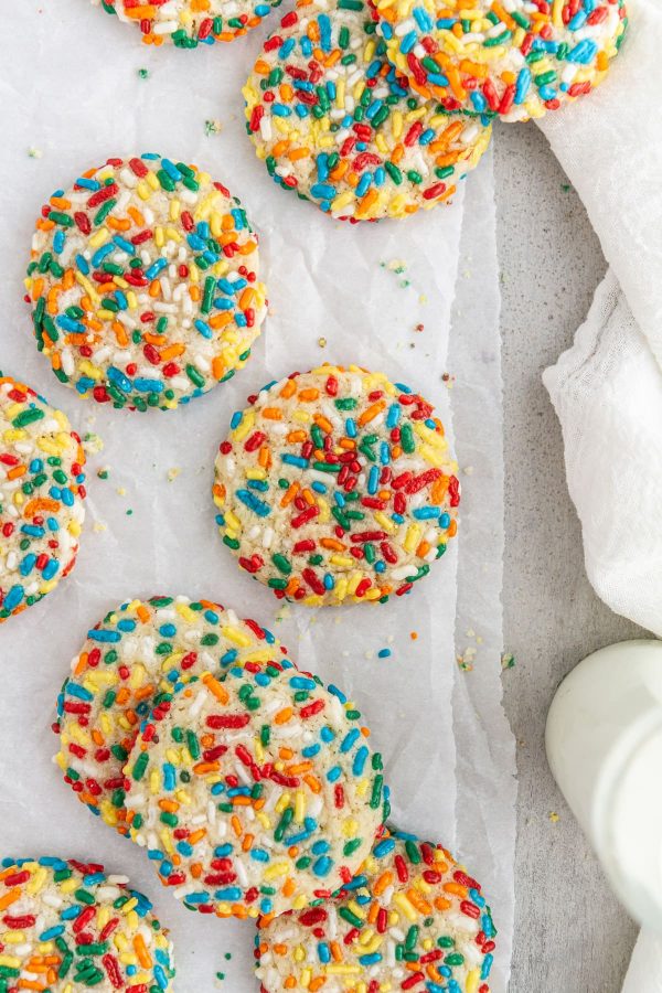 confetti cookies on a sheet of parchment paper.