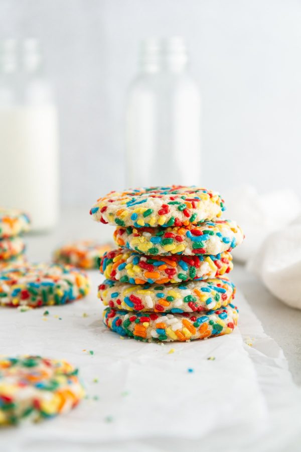 stack of confetti cookies on parchment paper.