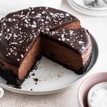 sliced chocolate cheesecake on white plate.