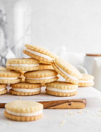 maple cream cookies stacked on a cutting board
