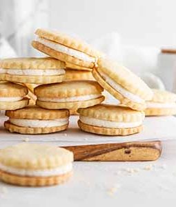 maple cream cookies stacked on a cutting board