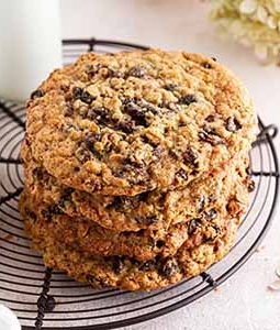 stack of giant oatmeal-raisin cookies on a cooling rack