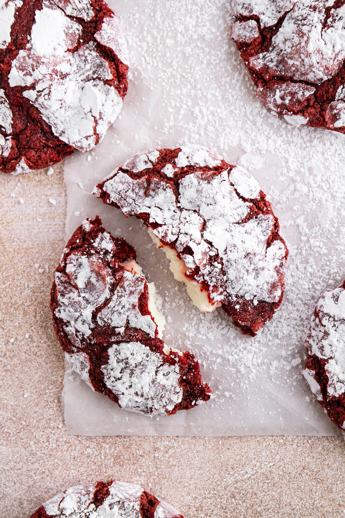 overhead shot of red velvet crinkle cookie broken in half