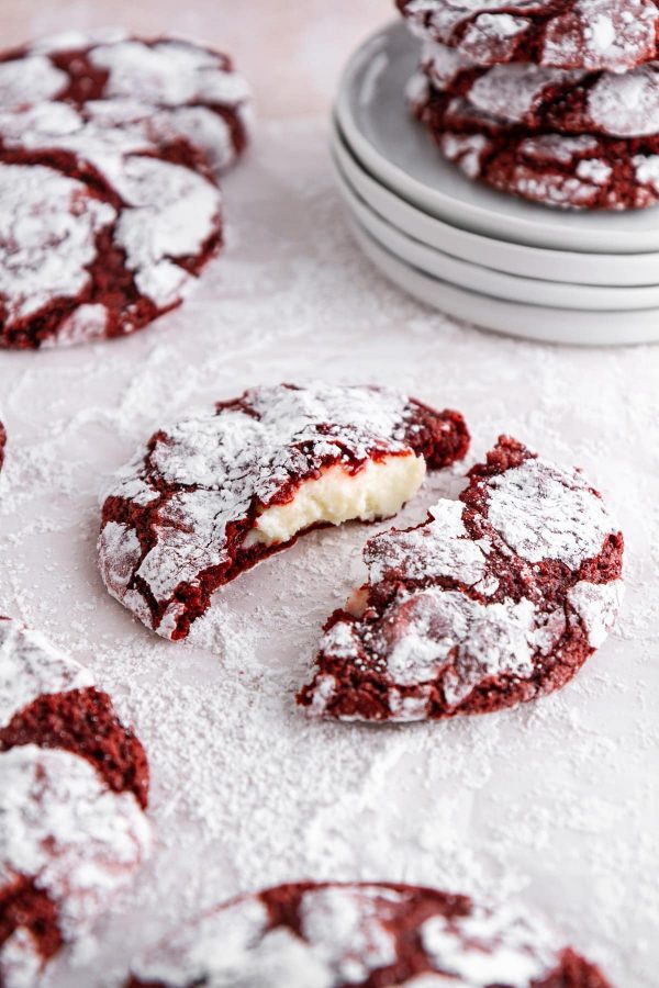 red velvet cookies on a surface covered with powdered sugar