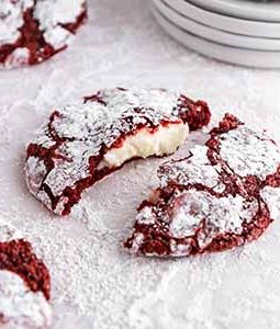 red velvet cookies on a surface covered with powdered sugar