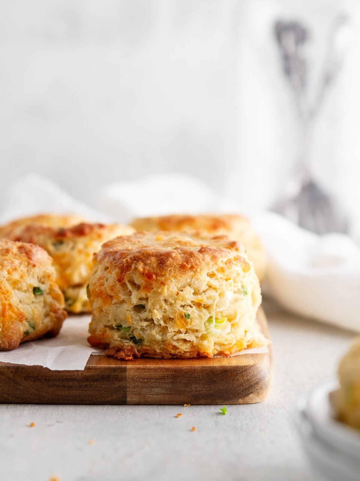 cheddar-scallion biscuits on a cutting board.
