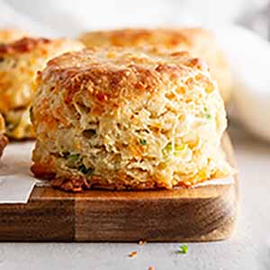 cheddar-scallion biscuit on a cutting board.