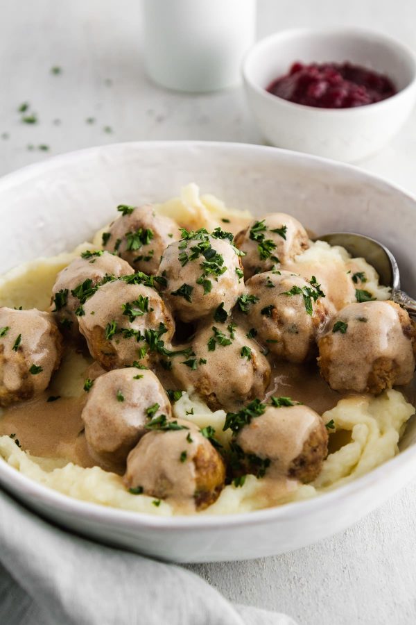 crockpot swedish meatballs in a bowl with mashed potatoes