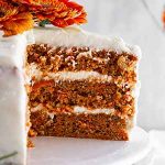 close-up of slice of carrot cake on a cake stand