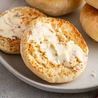 buttered English muffins on a plate