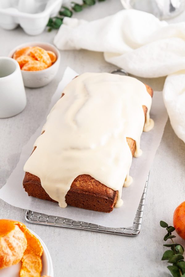 iced clementine pound cake on a cooling rack