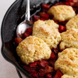 rhubarb cobbler being served with a silver serving spoon.