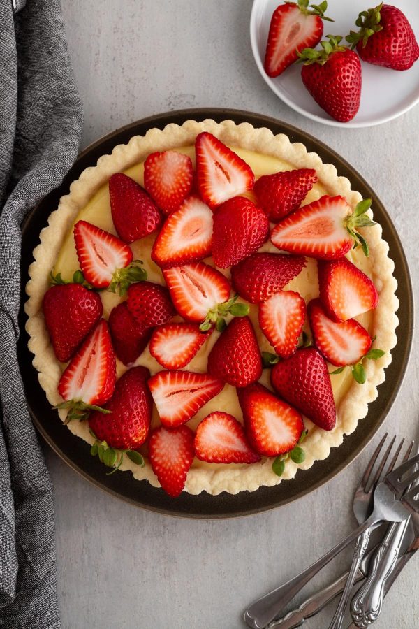 strawberry custard tart on a plate