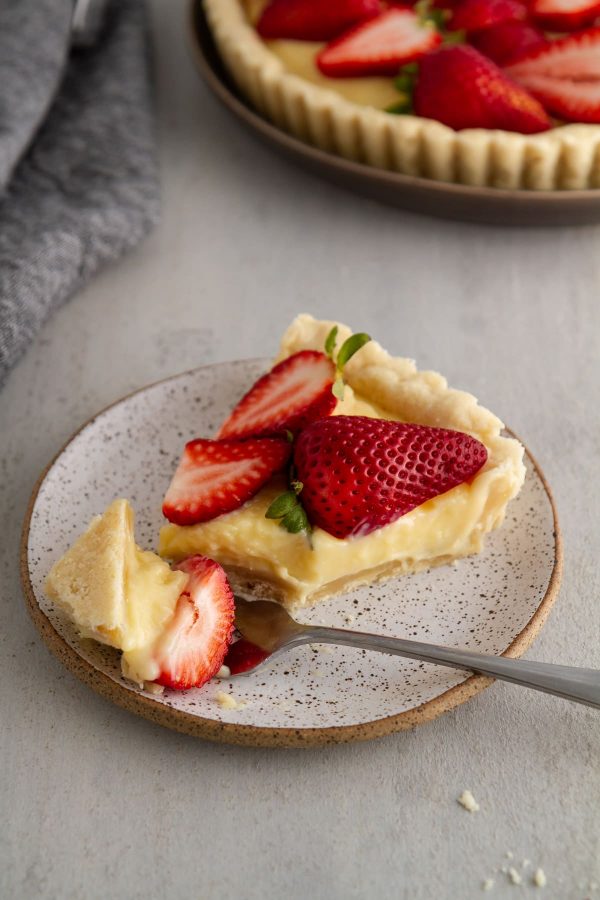 slice of strawberry custard tart on a plate