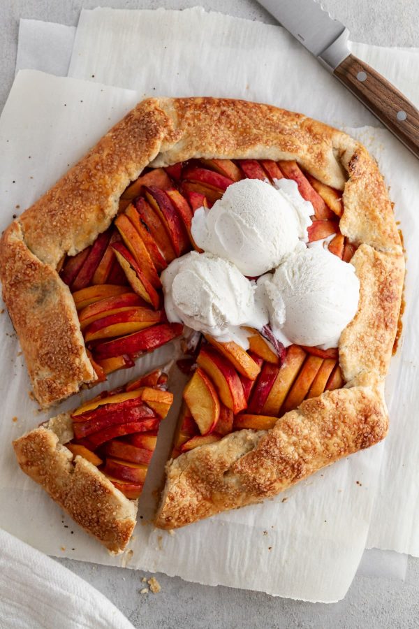 overhead shot of peach galette on parchment paper