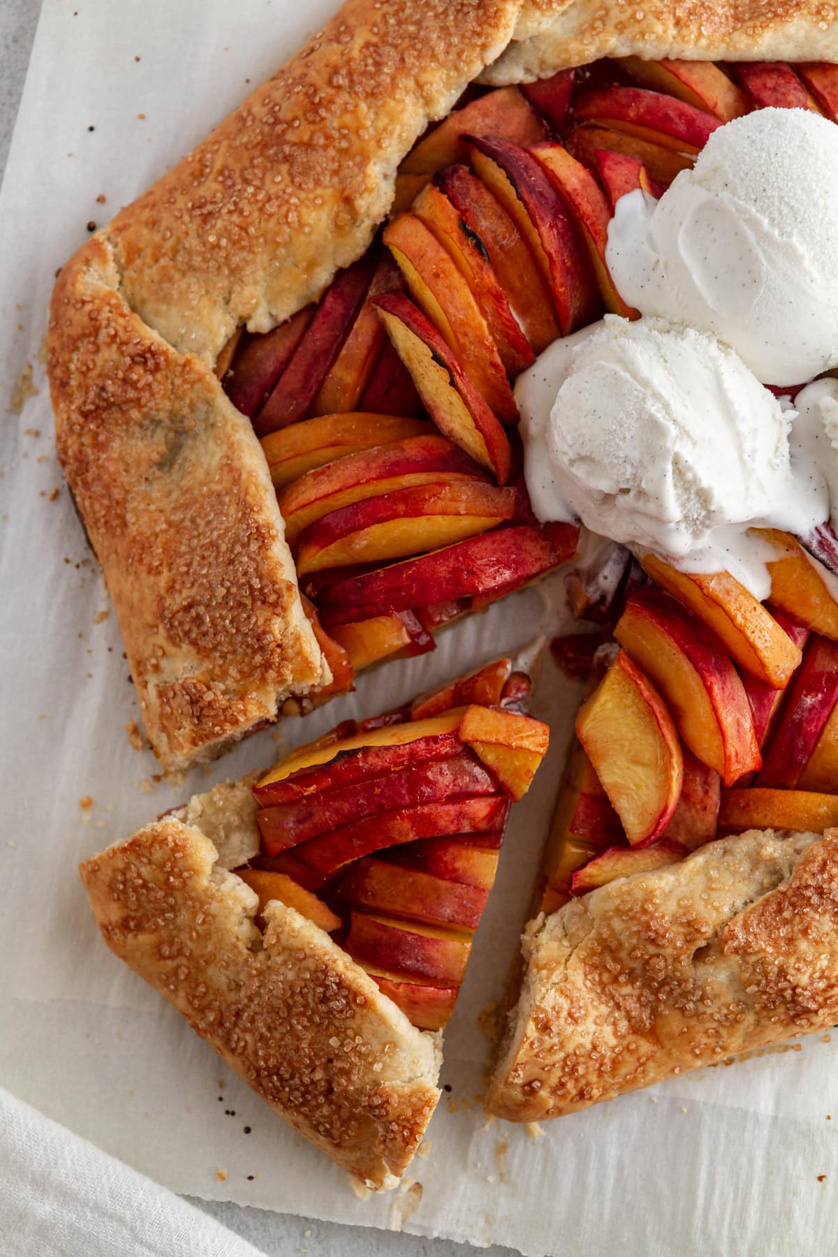 overhead shot of slice of peach galette taken out of pie