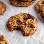 a cookie with a bite taken out of it on a surface.