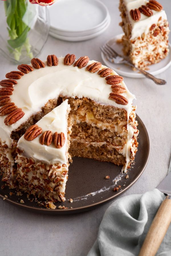 Hummingbird cake on a plate with slices taken out