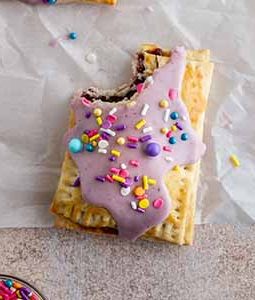 pop tart on a surface with a bite taken out of it