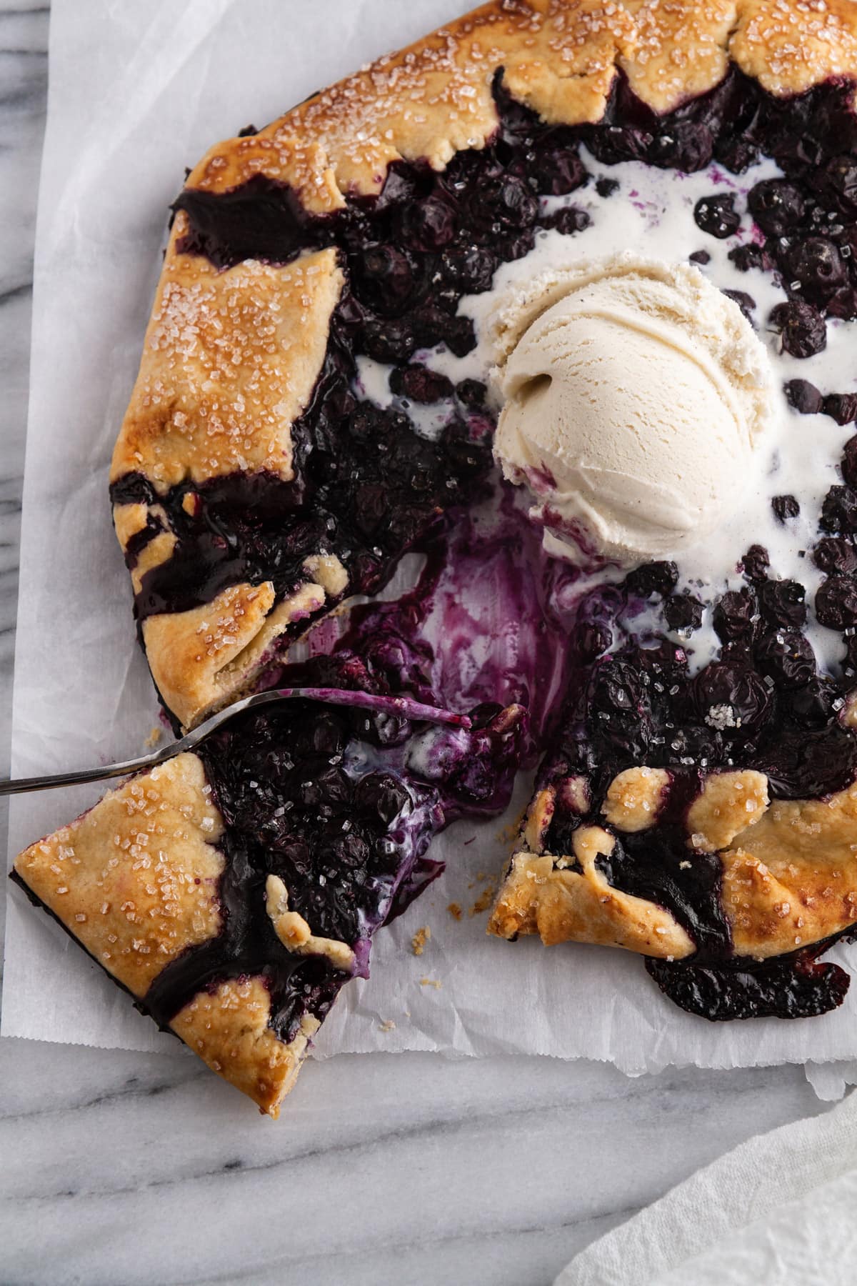 slice of blueberry galette taken out of pie