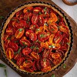 summer tomato tart on a cutting board.