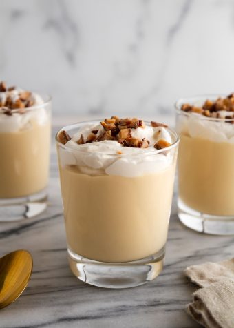 glasses of butterscotch pudding on a surface